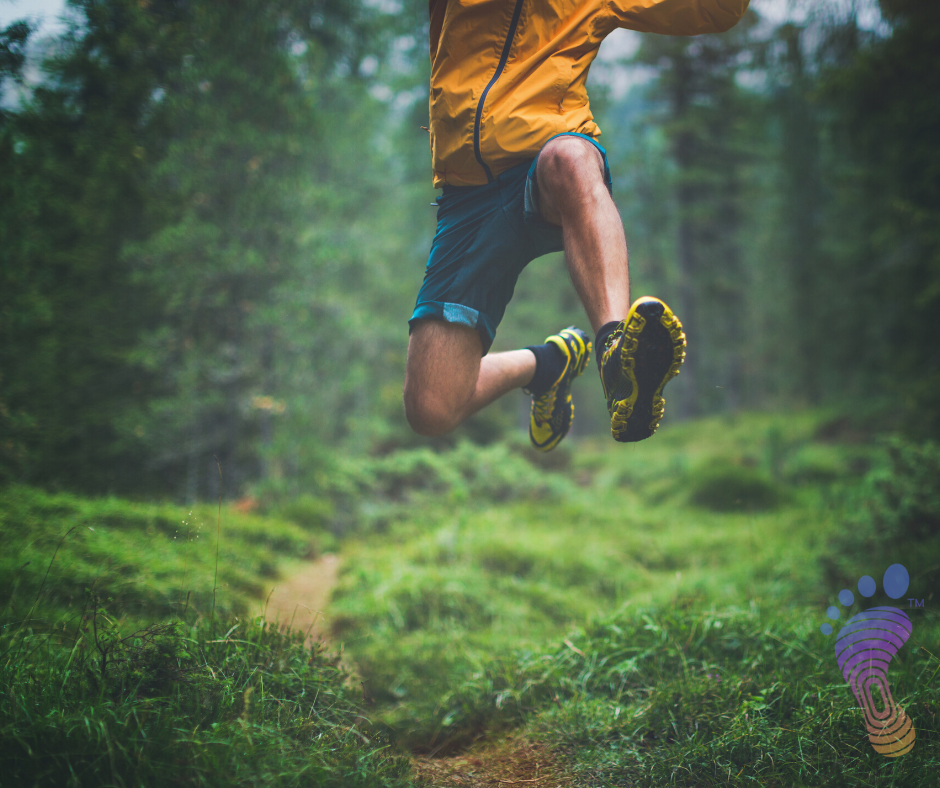 Athlete running and jumping as he runs through the woods